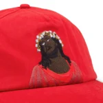 denim-tears-black-jesus-red-cap
